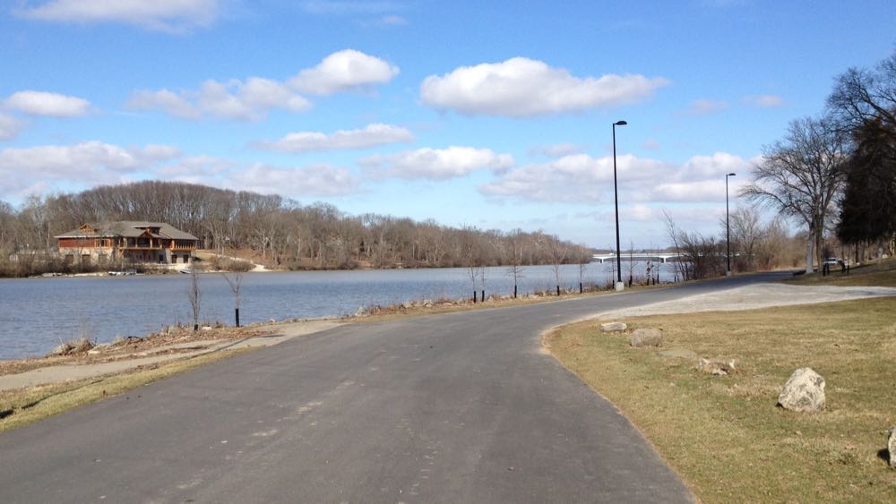 The main road through Griggs Reservoir Park with a view of the Scioto River in the background.